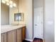 Bathroom featuring ample vanity storage and updated laminate floors at 817 Grand Canal Dr, Kissimmee, FL 34759