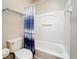 Bathroom with tub and shower featuring blue patterned shower curtain at 817 Grand Canal Dr, Kissimmee, FL 34759