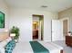 Bright bedroom features stylish decor, ensuite bathroom, and comfortable carpet flooring at 817 Grand Canal Dr, Kissimmee, FL 34759