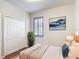 Cozy bedroom featuring wood floors, closet, and a serene blue and white art piece above the headboard at 817 Grand Canal Dr, Kissimmee, FL 34759