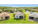 Aerial view of home with lush green lawn and trees at 817 Grand Canal Dr, Kissimmee, FL 34759