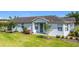 Charming single-story home featuring a well-manicured lawn, fresh landscaping, and a welcoming entrance at 817 Grand Canal Dr, Kissimmee, FL 34759