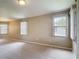 A well-lit room with neutral paint, large windows, and carpet flooring at 817 Grand Canal Dr, Kissimmee, FL 34759