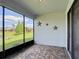 Relaxing screened patio with a view of the pond and landscaping at 817 Grand Canal Dr, Kissimmee, FL 34759