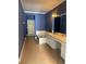 Bathroom with a soaking tub, double sink vanity, and tile flooring at 8369 Riverdale Ln # 1, Davenport, FL 33896