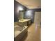 Bathroom featuring a large vanity with double sinks, soaking tub and tile flooring at 8369 Riverdale Ln # 1, Davenport, FL 33896