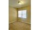 Bedroom with a large window and neutral colored walls at 8369 Riverdale Ln # 1, Davenport, FL 33896