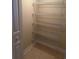 Empty closet featuring multiple metal shelves and tiled floors at 8369 Riverdale Ln # 1, Davenport, FL 33896