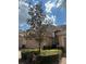 Charming home exterior featuring lush trees and landscaping with a two car garage and tile roof at 8369 Riverdale Ln # 1, Davenport, FL 33896