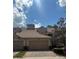 Beuatiful home exterior with two car garage, a tile roof, and well maintained landscaping at 8369 Riverdale Ln # 1, Davenport, FL 33896