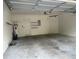 Spacious two car garage with water heater, storage shelves, and door to interior of home at 8369 Riverdale Ln # 1, Davenport, FL 33896