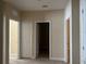 Hallway with multiple doors and neutral colored walls at 8369 Riverdale Ln # 1, Davenport, FL 33896