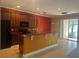Modern kitchen with dark cabinets, granite countertops, and stainless steel appliances at 8369 Riverdale Ln # 1, Davenport, FL 33896