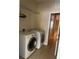 The laundry room includes a washer and dryer and has tile flooring at 8369 Riverdale Ln # 1, Davenport, FL 33896