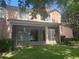View of a screened porch with ceiling fan overlooking the green backyard of this charming two-story home at 8369 Riverdale Ln # 1, Davenport, FL 33896
