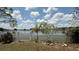 A white picket fence surrounds the lush backyard, offering picturesque views of the tranquil lake at 954 Hacienda Cir, Kissimmee, FL 34741