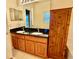 Bathroom featuring double sinks, a vanity with storage, and a large mirror at 954 Hacienda Cir, Kissimmee, FL 34741