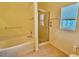 Bathroom showcasing a tub and shower with a glass door enclosure at 954 Hacienda Cir, Kissimmee, FL 34741