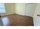 Bedroom showcasing a closet, window and wood-look flooring at 954 Hacienda Cir, Kissimmee, FL 34741