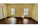 Bedroom with wood-look floors and natural light from two windows at 954 Hacienda Cir, Kissimmee, FL 34741