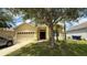 Charming single-story home with a well-manicured lawn and a two-car garage at 954 Hacienda Cir, Kissimmee, FL 34741