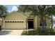 Charming single-Gathering home with a two-car garage and well-manicured lawn, offering classic curb appeal at 954 Hacienda Cir, Kissimmee, FL 34741