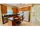 Functional kitchen featuring wood cabinets, granite countertops, and a convenient center island at 954 Hacienda Cir, Kissimmee, FL 34741
