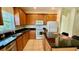 Well-equipped kitchen with wood cabinets, granite countertops, and modern appliances at 954 Hacienda Cir, Kissimmee, FL 34741