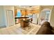 Well-lit kitchen with wood cabinetry, granite countertops, stainless steel dishwasher and an island with chairs at 954 Hacienda Cir, Kissimmee, FL 34741