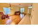 Bright living room with wood flooring, large windows, and a comfortable seating area at 954 Hacienda Cir, Kissimmee, FL 34741