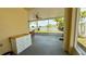 A cozy screened patio features a charming accent cabinet and serene views of the yard at 954 Hacienda Cir, Kissimmee, FL 34741