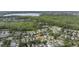 An aerial shot showcases a quiet neighborhood near a wooded area, offering a serene and private living environment at 14314 Pleach St, Winter Garden, FL 34787
