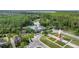 Aerial view showcases the community amenities including a pool, clubhouse and clock tower at 14314 Pleach St, Winter Garden, FL 34787