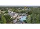 A relaxing community pool surrounded by well-maintained landscaping and mature trees near residential homes at 14314 Pleach St, Winter Garden, FL 34787