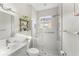 Modern bathroom featuring a glass-enclosed shower, neutral tile, and stylish fixtures at 14314 Pleach St, Winter Garden, FL 34787