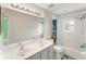 Bright bathroom featuring a double sink vanity, tub with shower, and ample natural light at 14314 Pleach St, Winter Garden, FL 34787