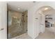 The bathroom has a walk-in glass shower with stylish tile and a view of the main bedroom at 14314 Pleach St, Winter Garden, FL 34787