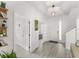 Bright foyer featuring modern wood-look tile, an inviting entrance, and convenient access to other rooms at 14314 Pleach St, Winter Garden, FL 34787