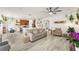 Open-concept living space connecting the kitchen, dining area, and living room, featuring modern decor at 14314 Pleach St, Winter Garden, FL 34787