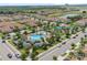 Stunning aerial view of community pool, playgrounds, and community near pond, houses, and landscaping at 1000 Blackwolf Run Rd, Davenport, FL 33896