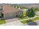 Well-maintained home with a two-car garage, lush landscaping, and a tile roof at 1000 Blackwolf Run Rd, Davenport, FL 33896