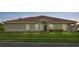 Attractive one-story home featuring a lush green lawn and classic tile roof at 1000 Blackwolf Run Rd, Davenport, FL 33896