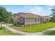 Beautifully landscaped home with a tile roof, well-maintained lawn, and a two-car garage at 1000 Blackwolf Run Rd, Davenport, FL 33896