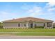 Charming one-story home featuring a well-manicured lawn, neutral stucco, and a classic tile roof at 1000 Blackwolf Run Rd, Davenport, FL 33896