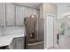 Kitchen featuring stainless steel refrigerator and access to the entry hall and living room at 1000 Blackwolf Run Rd, Davenport, FL 33896