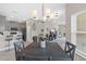 Stylish open-concept kitchen with gray cabinets, modern appliances, and a dining area at 1000 Blackwolf Run Rd, Davenport, FL 33896