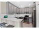Updated kitchen showcases gray cabinets, stainless steel appliances, and a breakfast bar at 1000 Blackwolf Run Rd, Davenport, FL 33896