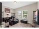 Inviting living room with plush carpet, comfortable seating, and ample natural light from the double windows at 1000 Blackwolf Run Rd, Davenport, FL 33896