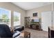 Comfortable living room boasts an entertainment center, leather seating, and plenty of natural light at 1000 Blackwolf Run Rd, Davenport, FL 33896