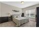 Serene main bedroom features a large bed, dresser, and modern decor with ample natural light at 1000 Blackwolf Run Rd, Davenport, FL 33896